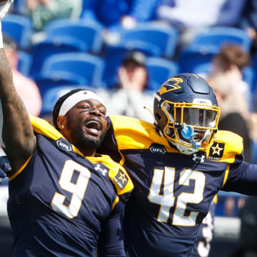 Showboat’s Maximillian Roberts (9) holds up the ball in celebration with Jordan Ferguson (42) after making a stop during the UFL game between the San Antonio Brahmas and Memphis Showboats in Simmons Bank Liberty Stadium in Memphis, Tenn., on Saturday, April 6, 2024.