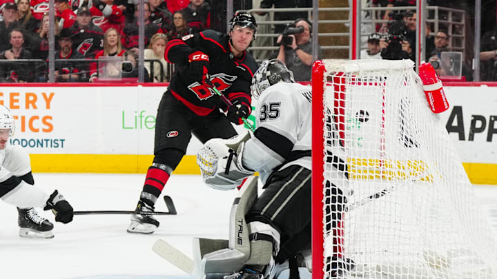 Feb 1, 2025; Raleigh, North Carolina, USA;  Los Angeles Kings goaltender Darcy Kuemper (35) stops the shot by Carolina Hurricanes right wing Mikko Rantanen (96) during the third period at Lenovo Center. Mandatory Credit: James Guillory-Imagn Images