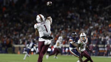 Nov 25, 2023; Charlottesville, Virginia, USA; Virginia Tech Hokies quarterback Kyron Drones (1) throws a touchdown pass against the Virginia Cavaliers during the third quarter at Scott Stadium. Mandatory Credit: Geoff Burke-USA TODAY Sports