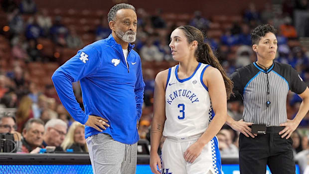 Kentucky coach Kenny Brooks stands next to guard Georgia Amoore.