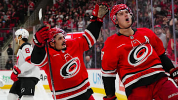 Dec 28, 2024; Raleigh, North Carolina, USA;  Carolina Hurricanes center Sebastian Aho (20) celebrates his goal with center Seth Jarvis (24) against the New Jersey Devils during the third period at Lenovo Center. Mandatory Credit: James Guillory-Imagn Images