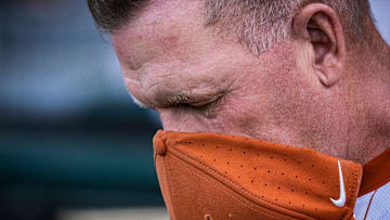 Texas Head Coach Jim Schlossnagle puts his hat over his face during the National Anthem ahead of the Longhorns' game against the UTSA Roadrunners, March 18, 2025 at UFCU Disch-Falk Field in Austin.