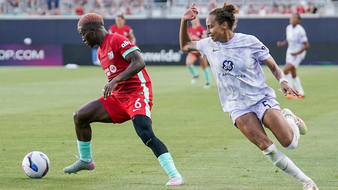Kansas City Current forward Temwa Chawinga (6) wins the ball from Racing Louisville FC defender Ellie Jean (5) d