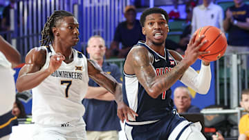 Nov 29, 2024; Paradise Island, Bahamas, BHS;  Arizona Wildcats guard Caleb Love (1) drives to the basket as West Virginia Mountaineers guard Javon Small (7) defends during the first half at Imperial Arena at the Atlantis resort.  Mandatory Credit: Kevin Jairaj-Imagn Images