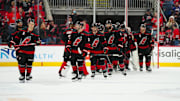 Mar 11, 2025; Raleigh, North Carolina, USA;  Carolina Hurricanes players celebrate their victory against the Tampa Bay Lightning at Lenovo Center. Mandatory Credit: James Guillory-Imagn Images