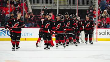 Mar 11, 2025; Raleigh, North Carolina, USA;  Carolina Hurricanes players celebrate their victory against the Tampa Bay Lightning at Lenovo Center. Mandatory Credit: James Guillory-Imagn Images