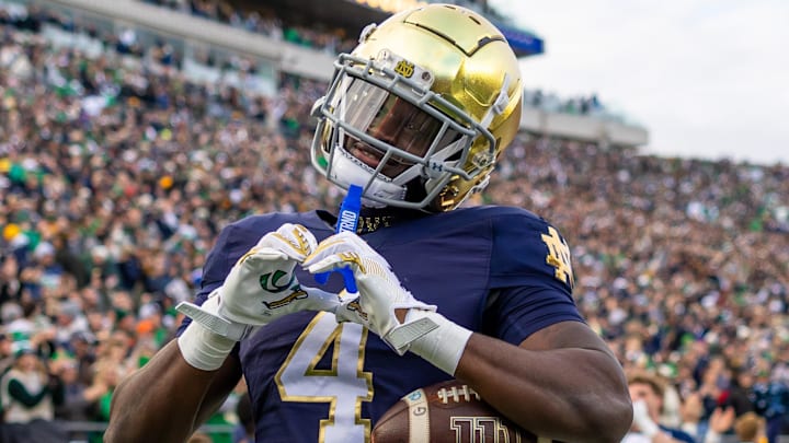 Nov 22, 2025; South Bend, Indiana, USA; Notre Dame Fighting Irish running back Jeremiyah Love (4) celebrates scoring against the Syracuse Orange during the first half at Notre Dame Stadium. Mandatory Credit: Michael Caterina-Imagn Images