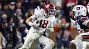 Nov 29, 2025; Auburn, Alabama, USA; Alabama Crimson Tide defensive back Bray Hubbard (18) intercepts the ball against Auburn Tigers running back Omar Mabson II (29) and quarterback Ashton Daniels (12) during the second half at Jordan-Hare Stadium. Mandatory Credit: John Reed-Imagn Images