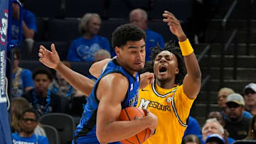 Memphis' Nicholas Jourdain (2) spins away with the ball after colliding with Missouri's Anthony Robinson II (0) during the game between the University of Memphis and Missouri at FedExForum in Memphis, Tenn., on Monday, November 4, 2024.