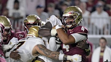 Sep 2, 2024; Tallahassee, Florida, USA; Florida State Seminoles quarterback DJ Uiagalelei (4) is tackled against the Boston College Eagles at Doak S. Campbell Stadium. Mandatory Credit: Melina Myers-Imagn Images