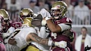 Florida State Seminoles quarterback DJ Uiagalelei is tackled against the Boston College Eagles
