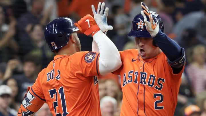 Jul 12, 2024; Houston, Texas, USA;  Houston Astros catcher Yainer Diaz (21) celebrates third baseman Alex Bregman (2) home run against the Texas Rangers in the fifth inning at Minute Maid Park.