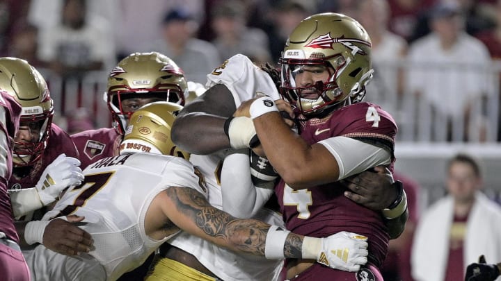 Sep 2, 2024; Tallahassee, Florida, USA; Florida State Seminoles quarterback DJ Uiagalelei (4) is tackled against the Boston College Eagles at Doak S. Campbell Stadium. 