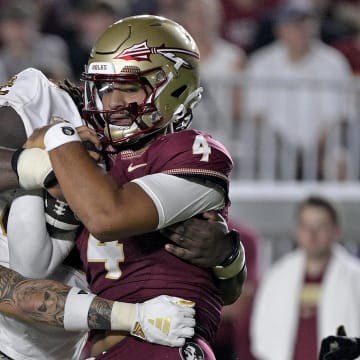 Florida State Seminoles quarterback DJ Uiagalelei is tackled against the Boston College Eagles at Doak S. Campbell Stadium. The Eagles' defense pressured Uiagalelei all night and won the battle in the trenches to upset No. 10 Florida State 28-13.