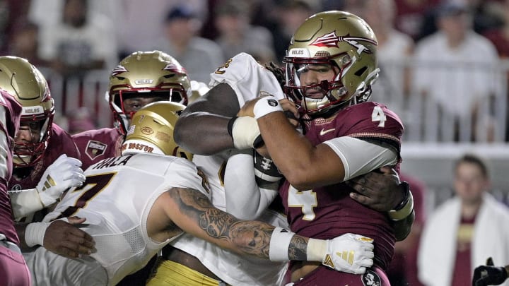 Sep 2, 2024; Tallahassee, Florida, USA; Florida State Seminoles quarterback DJ Uiagalelei (4) is tackled against the Boston College Eagles at Doak S. Campbell Stadium. Mandatory Credit: Melina Myers-USA TODAY Sports