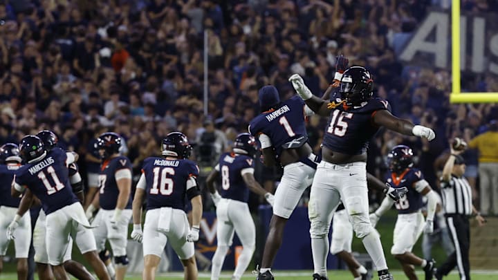 Sep 26, 2025; Charlottesville, Virginia, USA; Virginia Cavaliers defensive lineman Hunter Osborne (15) Cavaliers wide receiver Suderian Harrison (1) celebrate after making a stop on a fourth down against the Florida State Seminoles during the fourth quarter at Scott Stadium. Mandatory Credit: Geoff Burke-Imagn Images