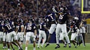 Sep 26, 2025; Charlottesville, Virginia, USA; Virginia Cavaliers defensive lineman Hunter Osborne (15) Cavaliers wide receiver Suderian Harrison (1) celebrate after making a stop on a fourth down against the Florida State Seminoles during the fourth quarter at Scott Stadium. Mandatory Credit: Geoff Burke-Imagn Images