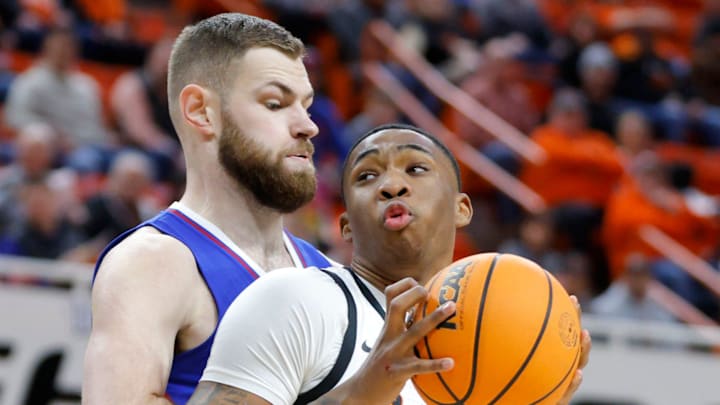 Oklahoma State Cowboys center Brandon Garrison (23) tries to get past Kansas Jayhawks center Hunter Dickinson (1) during a college basketball game between the Oklahoma State University Cowboys (OSU) and the Kansas Jayhawks at Gallagher-Iba Arena in Stillwater, Okla., Tuesday, Jan. 16, 2024.