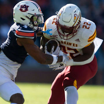 Louisiana-Monroe Warhawks running back Ahmad Hardy (22) breaks a tackle attempt from Auburn Tigers defensive back Kayin Lee (4) as Auburn Tigers take on Louisiana-Monroe Warhawks at Jordan-Hare Stadium in Auburn, Ala., on Saturday, Nov. 16, 2024. Auburn Tigers lead Louisiana-Monroe Warhawks 24-0 at halftime.