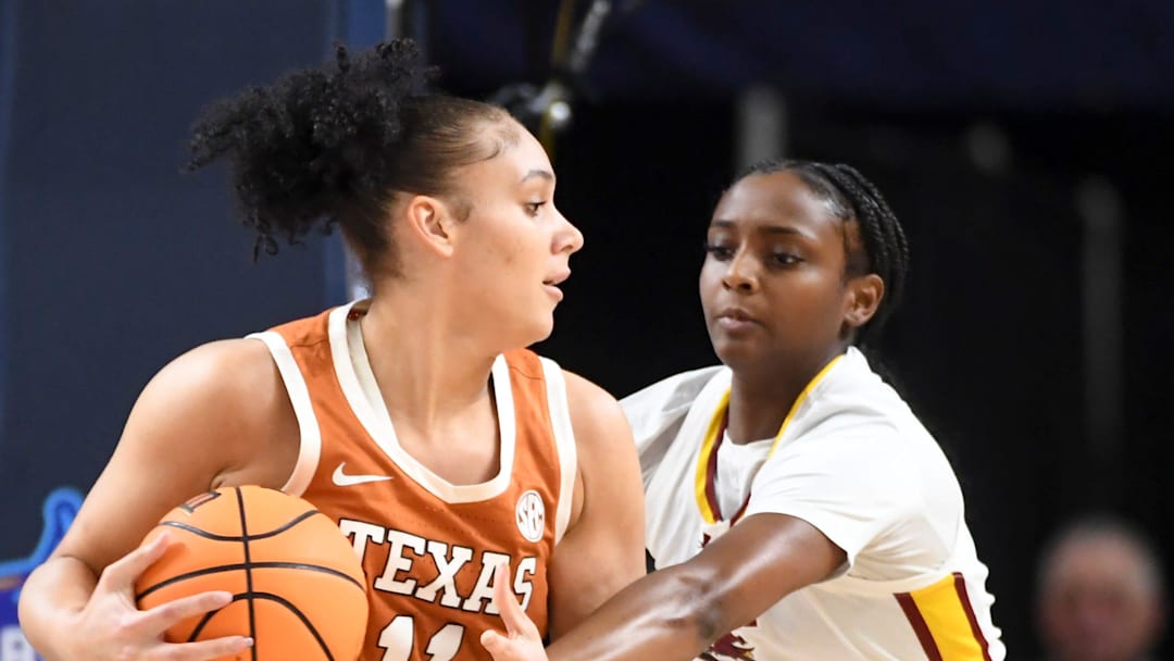 Texas Longhorns forward Justice Carlton (11) is defended by South Carolina Gamecocks guard Ta'niya Latson (00) Sunday, March 8, 2026, during the SEC Women's Basketball Tournament Championship game at Bon Secours Wellness Arena in Greenville, South Carolina.