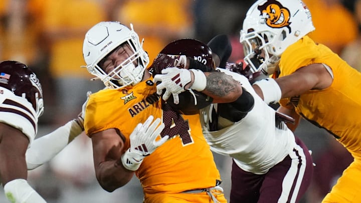 Arizona State running back Cam Skattebo runs the ball as Mississippi State Bulldogs safety Isaac Smith tries to tackle him at Mountain America Stadium in Tempe on Sept. 7, 2024.