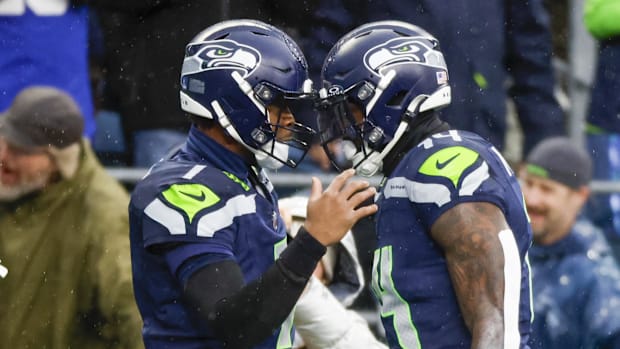Seattle Seahawks quarterback Geno Smith (7) celebrates with Seattle Seahawks wide receiver DK Metcalf (14)