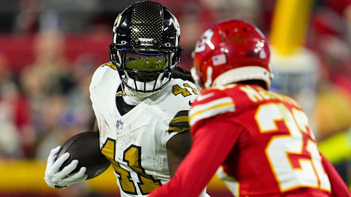 New Orleans Saints running back Alvin Kamara (41) runs the ball against Kansas City Chiefs cornerback Trent McDuffie (22) during the second half at GEHA Field at Arrowhead Stadium.