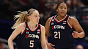 Apr 4, 2025; Tampa, FL, USA;  Connecticut Huskies guard Paige Bueckers (5) high fives Connecticut Huskies forward Sarah Strong (21) during first half in a semifinal of the women's 2025 NCAA tournament against the UCLA Bruins at Amalie Arena.