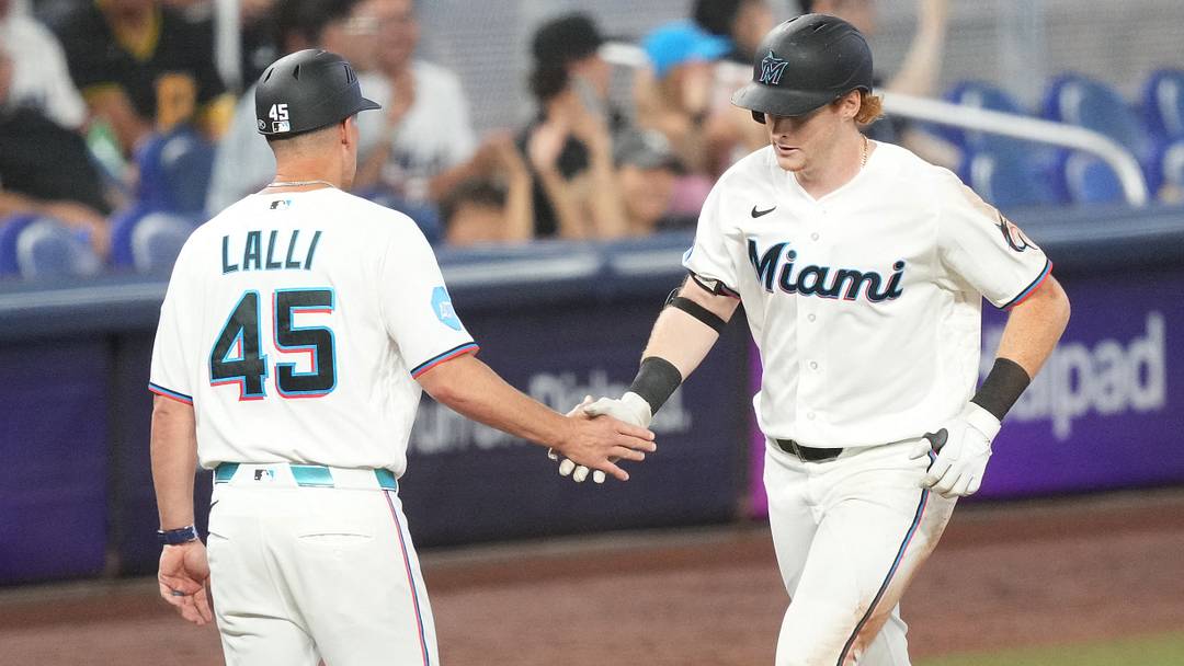 Miami Marlins third-base coach Blake Lalli (45) congratulates Miami Marlins right fielder Owen Caissie (17) on his solo home run. Miami Marlins third-base coach Blake Lalli (45) congratulates Miami Marlins right fielder Owen Caissie (17) on his solo home run.