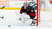 Dec 10, 2024; Raleigh, North Carolina, USA;  Carolina Hurricanes goaltender Pyotr Kochetkov (52) clears the puck away against the San Jose Sharks during the second period at Lenovo Center. Mandatory Credit: James Guillory-Imagn Images