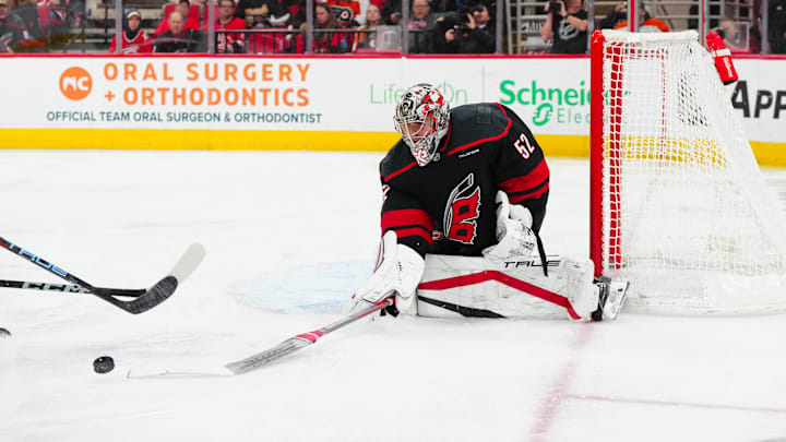Nov 5, 2024; Raleigh, North Carolina, USA;  Carolina Hurricanes goaltender Pyotr Kochetkov (52) comes out and pokes the puck away against the Philadelphia Flyers during the second period at Lenovo Center. Mandatory Credit: James Guillory-Imagn Images