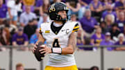 Sep 14, 2024; Greenville, North Carolina, USA;  Appalachian State Mountaineers quarterback Joey Aguilar (4) looks down field against the East Carolina Pirates during the second half at Dowdy-Ficklen Stadium. Mandatory Credit: James Guillory-Imagn Images
