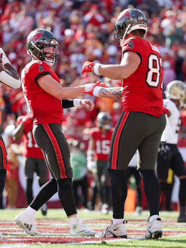 Tampa Bay Buccaneers quarterback Baker Mayfield celebrates with tight end Payne Durham.