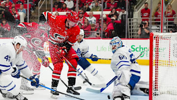 Apr 13, 2025; Raleigh, North Carolina, USA;  Toronto Maple Leafs goaltender Joseph Woll (60) stops the scoring attempt by Carolina Hurricanes right wing Andrei Svechnikov (37) during the first period at Lenovo Center. Mandatory Credit: James Guillory-Imagn Images