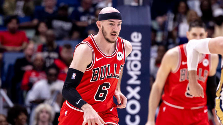 Feb 25, 2024; New Orleans, Louisiana, USA; Chicago Bulls guard Alex Caruso (6) brings the ball up court against New Orleans Pelicans center Jonas Valanciunas (17) during the second half at Smoothie King Center. Mandatory Credit: Stephen Lew-USA TODAY Sports