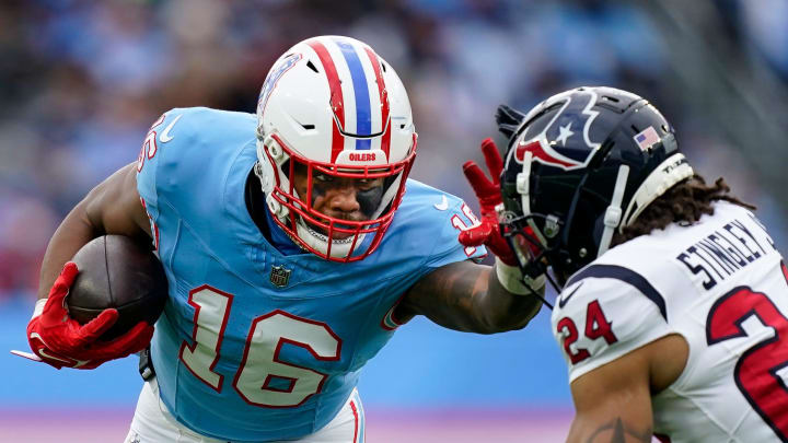 Tennessee Titans wide receiver Treylon Burks (16) stiff arms Houston Texans cornerback Derek Stingley during the 2023 season.