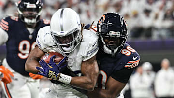 Dec 16, 2024; Minneapolis, Minnesota, USA; Minnesota Vikings running back Aaron Jones (33) is tackled by Chicago Bears defensive end Dominique Robinson (90) during the third quarter at U.S. Bank Stadium. Mandatory Credit: Jeffrey Becker-Imagn Images