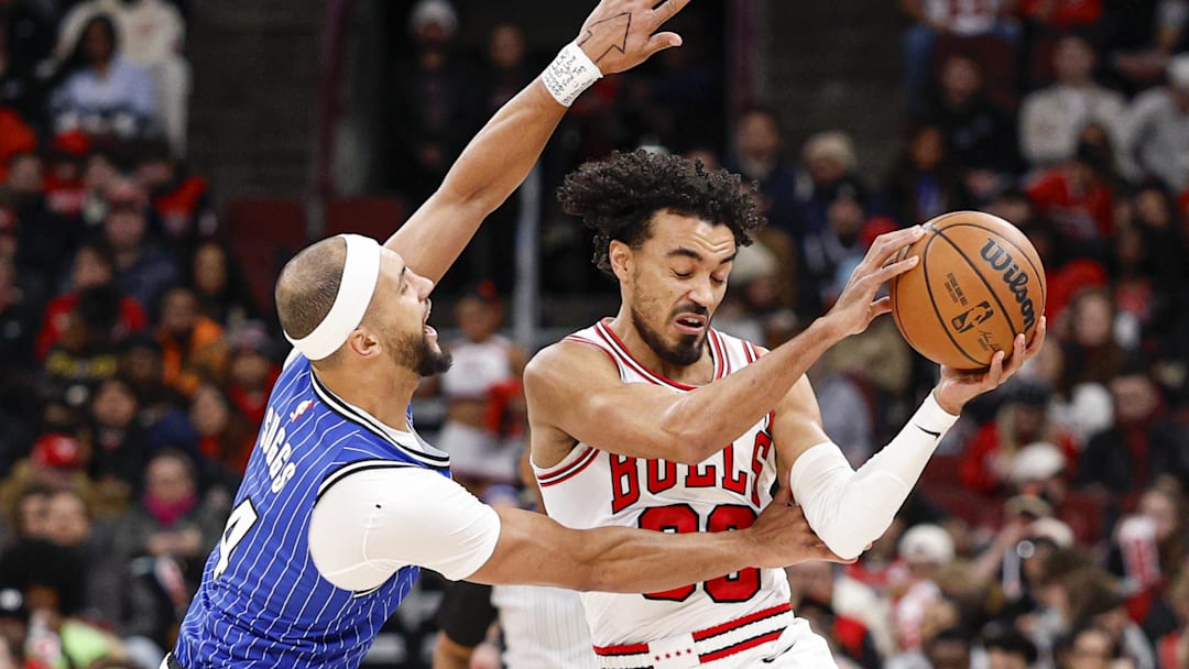 Jan 2, 2026; Chicago, Illinois, USA; Orlando Magic guard Jalen Suggs (4) defends against Chicago Bulls guard Tre Jones (30) during the first half at United Center. Mandatory Credit: Kamil Krzaczynski-Imagn Images