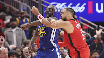 Apr 23, 2025; Houston, Texas, USA; Golden State Warriors forward Draymond Green (23) and Houston Rockets forward Dillon Brooks (9) tangle arms during the second quarter during game two of the first round for the 2024 NBA Playoffs at Toyota Center. Mandatory Credit: Troy Taormina-Imagn Images