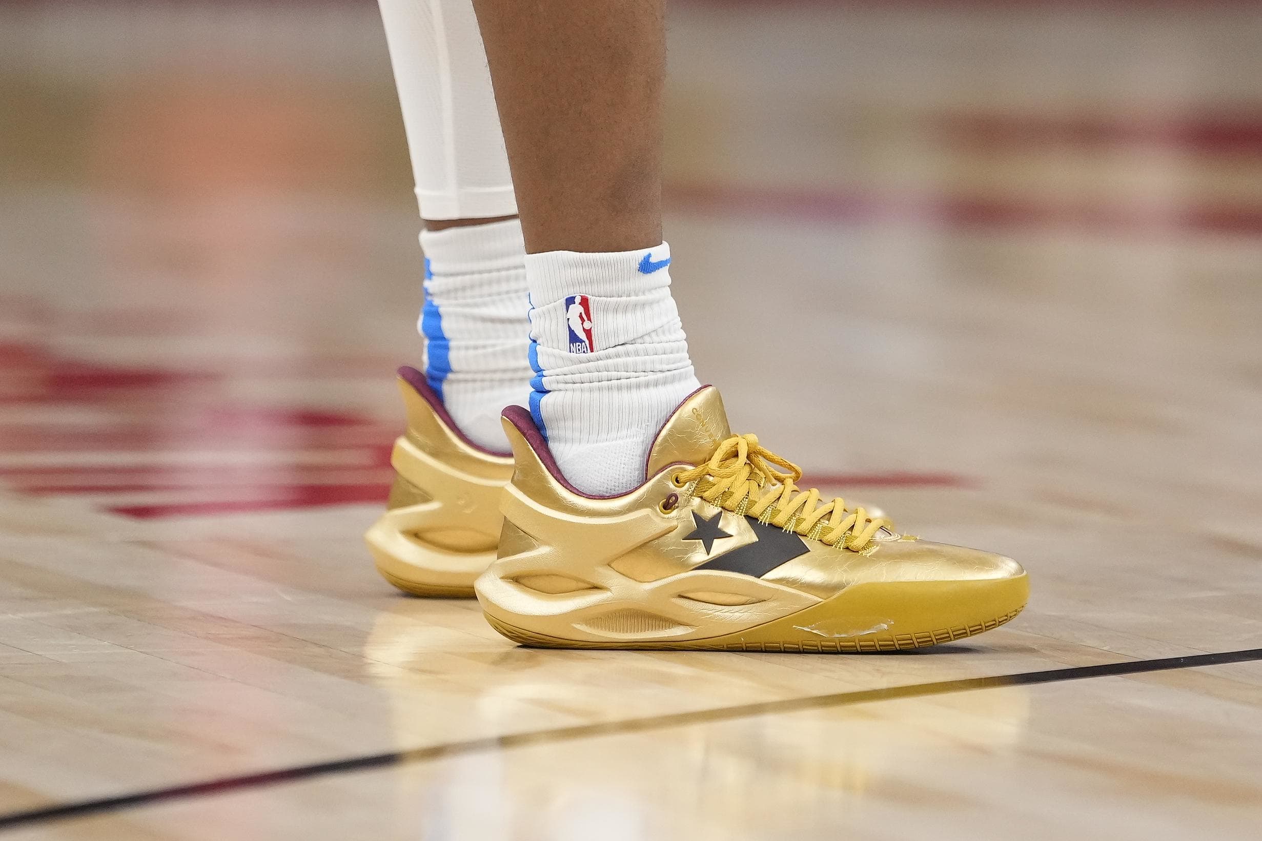 Oklahoma City Thunder guard Shai Gilgeous-Alexander's gold Converse sneakers.