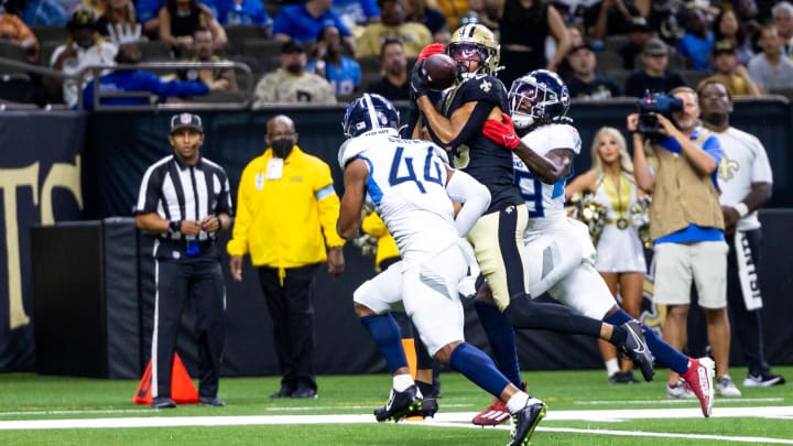 Aug 25, 2024; New Orleans, Louisiana, USA;  New Orleans Saints wide receiver Equanimeous St. Brown (13) catches a touchdown against Tennessee Titans safety Shyheim Carter (28) during the first half at Caesars Superdome. Mandatory Credit: Stephen Lew-USA TODAY Sports