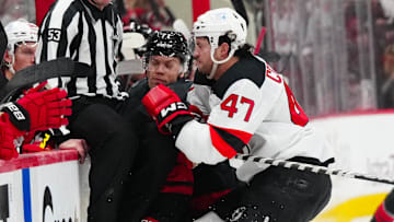 Paul Cotter (Devils forward #47) checking Taylor Hall (Hurricanes forward #71) in game two of the first round of the 2025 Stanley Cup Playoffs. 