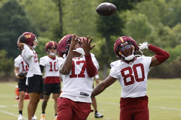 Wide receiver catches pass in practice.