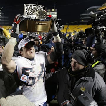 Jan 23, 2005; Pittsburgh, PA,  USA; New England Patriots linebacker Tedy Bruschi holds the AFC trophy in celebration after a victory over the Pittsburgh Steelers in the 2004 AFC Championship game at Heinz Field. Patriots beat the Steelers 41-27. Mandatory Credit: Matthew Emmons-Imagn Images