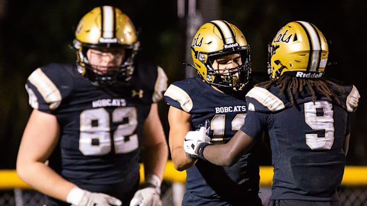 Buchholz Bobcats Justin Williams (13) is congratulated by Buchholz Bobcats wide receiver Dj Hicks (9) after scoring a touchdown in the second half. The Buchholz Bobcats hosted the Oakleaf Knights at Citizens Field in Gainesville, FL on Friday, November 29 2024 in the Class 6A-Region 1 Final. The Bobcats defeated the Knights 25-19 and advance to the final four. [Doug Engle/Ocala Star Banner]