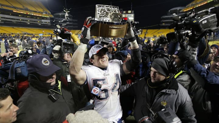 Jan 23, 2005; Pittsburgh, PA,  USA; New England Patriots linebacker Tedy Bruschi holds the AFC trophy in celebration after a victory over the Pittsburgh Steelers in the 2004 AFC Championship game at Heinz Field. Patriots beat the Steelers 41-27. Mandatory Credit: Matthew Emmons-Imagn Images