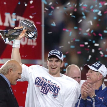 Eli Manning holds the trophy after Super Bowl XLII.

7xl00lnk