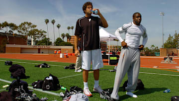 Apr 2, 2006; Los Angeles, CA, USA; Southern California Trojans quarterback (11) Matt Leinart and tailback (5) Reggie Bush prepare for the 2006 USC Pro Day at Katherine B. Loker Stadium in Los Angeles, CA. Mandatory Credit: Photo By Mark J. Rebilas-Imagn Images © Copyright Mark J. Rebilas