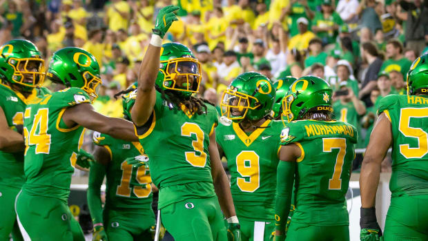 Oregon Ducks defensive back Brandon Johnson and fellow members of the Oregon defense celebrate an interception as the Oregon 