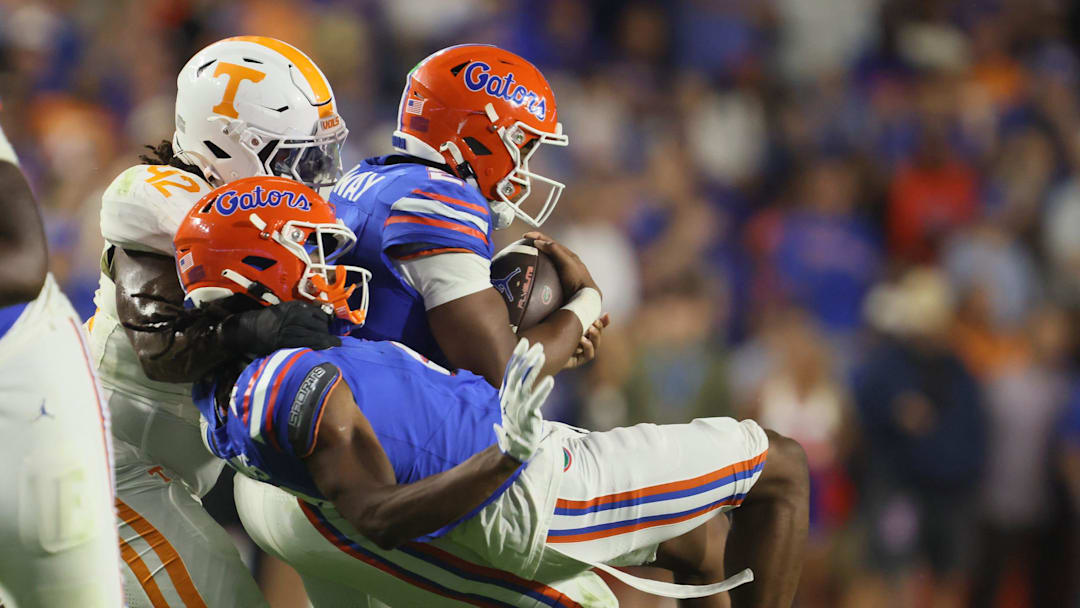Florida wide receiver TJ Abrams (4) and Florida quarterback DJ Lagway (2) gets snatched off their feet by Tennessee defensive lineman Joshua Josephs (19) and Tennessee defensive lineman Tyre West (42) during the second half of an NCAA football game against Tennessee at Steve Spurrier Field at Ben Hill Griffin Stadium in Gainesville, FL on Saturday, November 22, 2025. Florida lost to Tennessee 31-11[Alan Youngblood/Gainesville Sun]